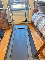 Full view of treadmill unfolded showing running surface and frame