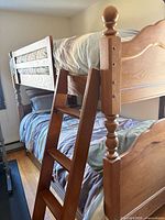 Overall view of bunk bed showing upper and lower bunks with ladder