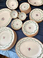Group view showing majority of pieces: stacks of plates, bowls, platters and cups