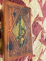 Top view showing carved floral lid with painted inset