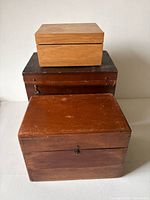 Three stacked wooden boxes closed