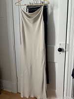 Full view of Babaton satin slip dress on hanger