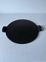 Top view of black pizza stone with handles