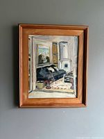 Framed oil painting on wall