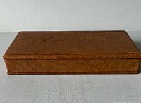 Closed brown pigskin jewelry box exterior view