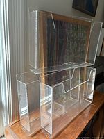 Three clear plexiglass display containers stacked