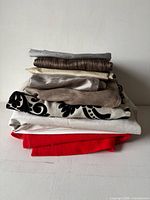 Stack of assorted fabric remnants in various colours and textures