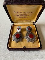 Front view of earrings in open presentation box