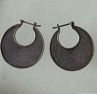 Front view of both silver textured hoop earrings
