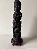 Full view of carved Tree of Life sculpture on stand