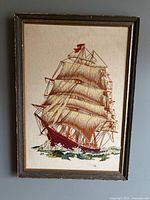 Full view of framed embroidered sailing ship artwork