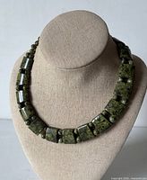full view of serpentine bead choker on display bust