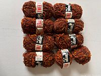 Stack of 10 skeins showing labels and color