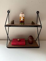 Full view of two-tier wall shelf with all decorative items displayed