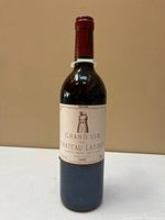 Full bottle front view showing intact label and capsule