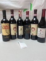 All six labeled wine bottles standing side by side