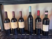 All six wine bottles standing on rack