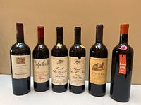 Front view of all six wine bottles standing