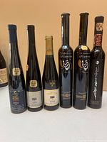 Front view of six assorted Niagara Peninsula VQA Icewine bottles showing labels and neck capsules
