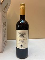 Single bottle front label showing La Petite Ecluse Pinot Noir information