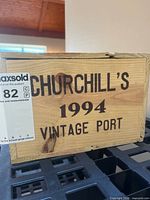 Front of pine crate showing Churchill's 1994 Vintage Port branding with MaxSold sticker
