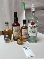 Group shot of all five sealed bottles on tabletop