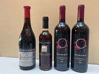 Group shot of four wine bottles front labels visible