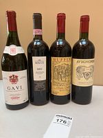 Front view of four wine bottles showing labels and vintages