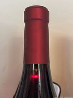 Top of bottle showing intact red capsule