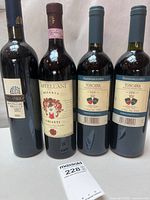 Front view all four wine bottles showing labels and sizes