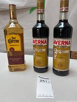 Front view showing one Jose Cuervo tequila bottle and two Averna liqueur bottles
