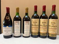 Front view of all six wine bottles showing labels and vintages