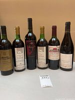 All six wine bottles lined up