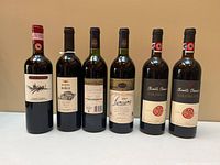 Front view of all six wine bottles showing labels and fill levels