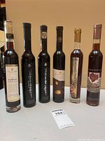 Group shot of all six icewine bottles standing upright on table