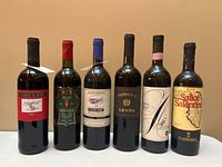 Front view of all six wine bottles showing labels