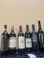 Frontal view of all six wine bottles upright on rack