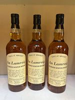Front view of three An Lamraig whisky bottles