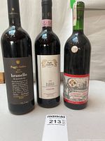 Front view of three wine bottles displaying labels and vintages