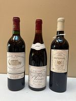 Front view of all three wine bottles showing labels and overall condition