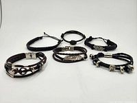 All six bracelets laid out showing styles and colors