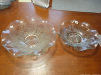 Two pressed glass bowls side-by-side showing relative sizes and pattern