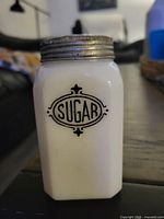 Front view showing "SUGAR" label and metal lid