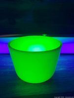 Bowl glowing vivid green under UV light