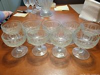Nine Iris & Herringbone coupe sherbet glasses grouped on table