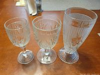 Front view of three Iris & Herringbone goblets showing pattern and size differences