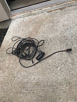 Coiled transducer cable with sensor and plug on concrete