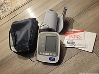 Monitor, cuff, carry case, manual on floor