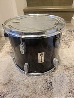 Front angled view showing full tom, lugs, hoop, badge