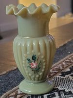 Front view showing ruffled rim, ribbed body, hobnail accents, painted rose motif